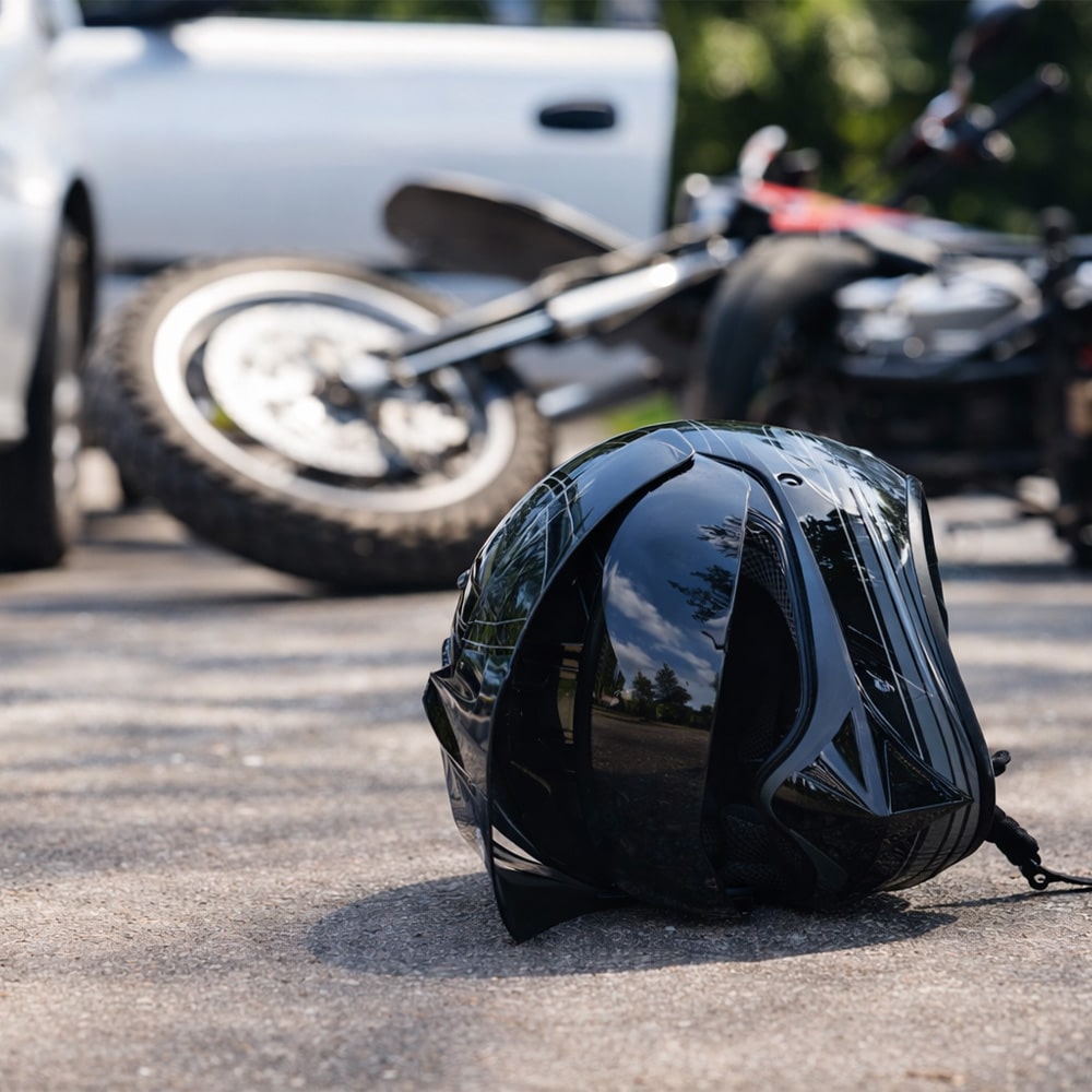 helmet next to a collapsed motorcycle